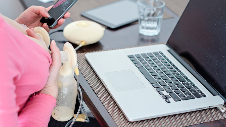 Person pumps breastmilk at desk