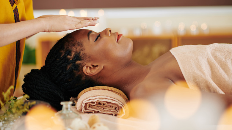 Woman eyes closed on spa table 