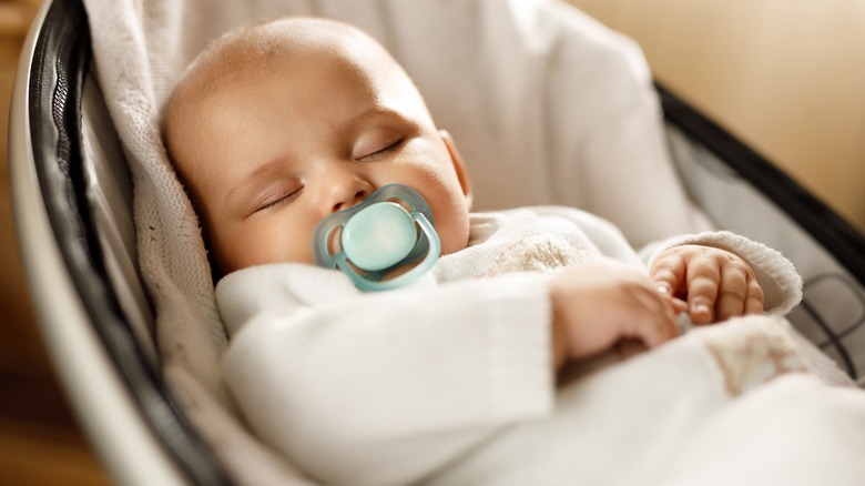 Sleeping baby in swing