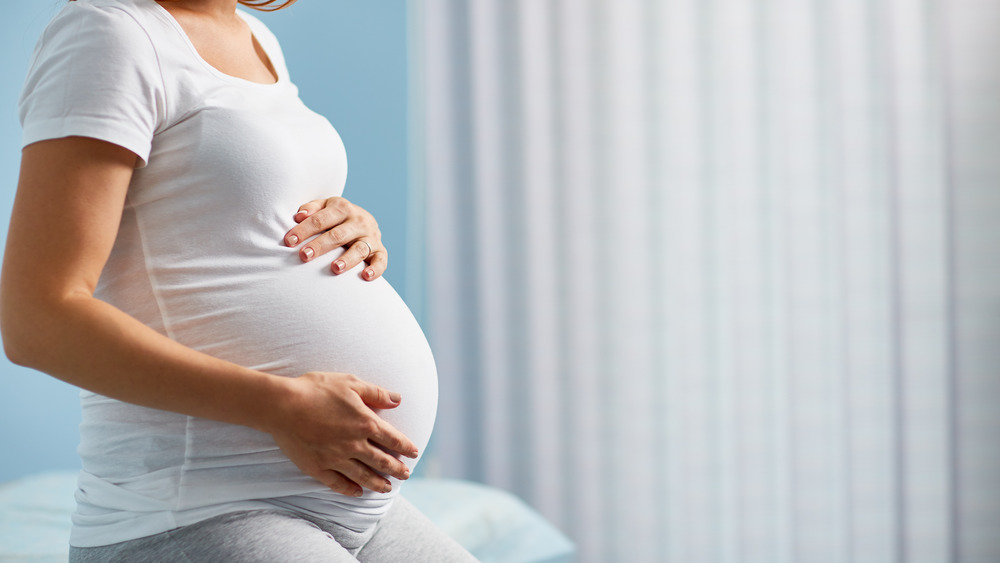 profile of pregnant woman's belly 