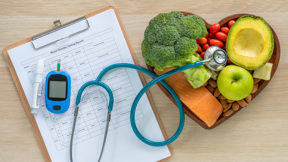 Healthy food in heart shape next to a clipboard