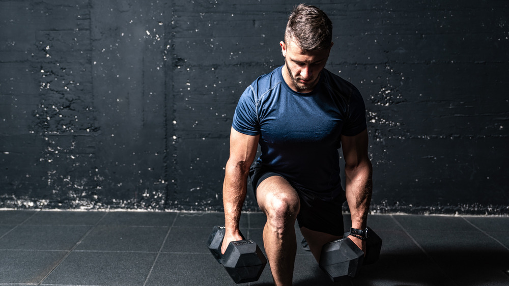 a man doing squats with added weight 