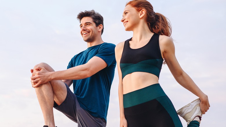 man and woman exercising outdoors