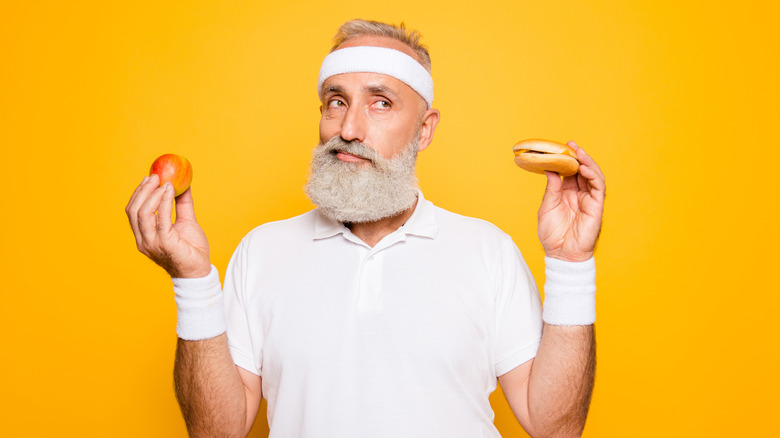 man holding food in each hand