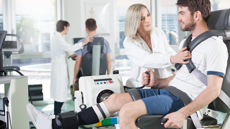 Man on isokinetic machine with dynamometer