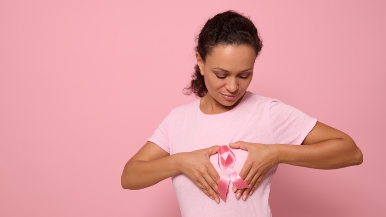 individual making heart sign over chest