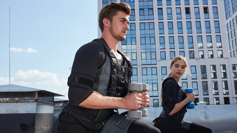 two athletes working out with weighted vests 