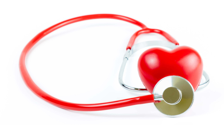 Stethoscope resting on stylized heart