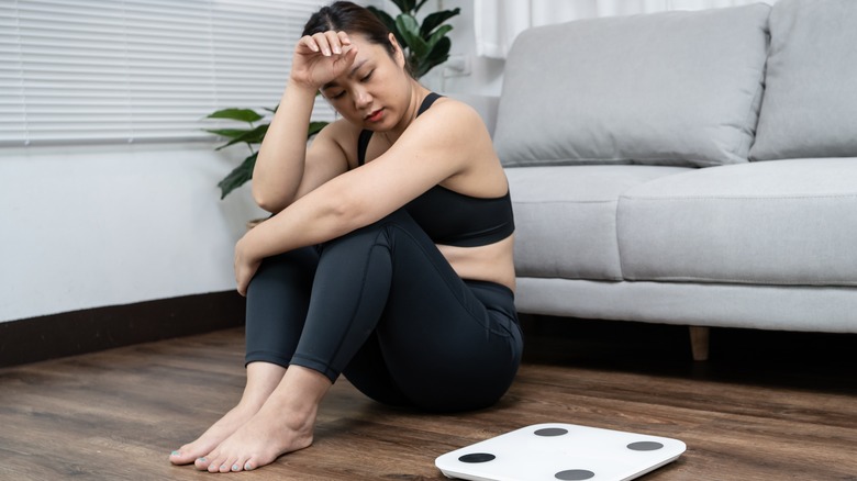 woman sitting on floor stressed