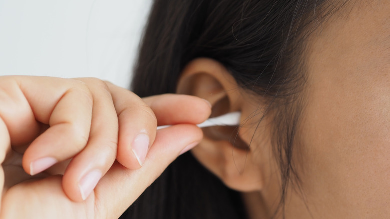 Woman holding a cotton swab