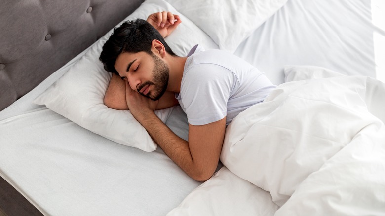 man asleep in bed