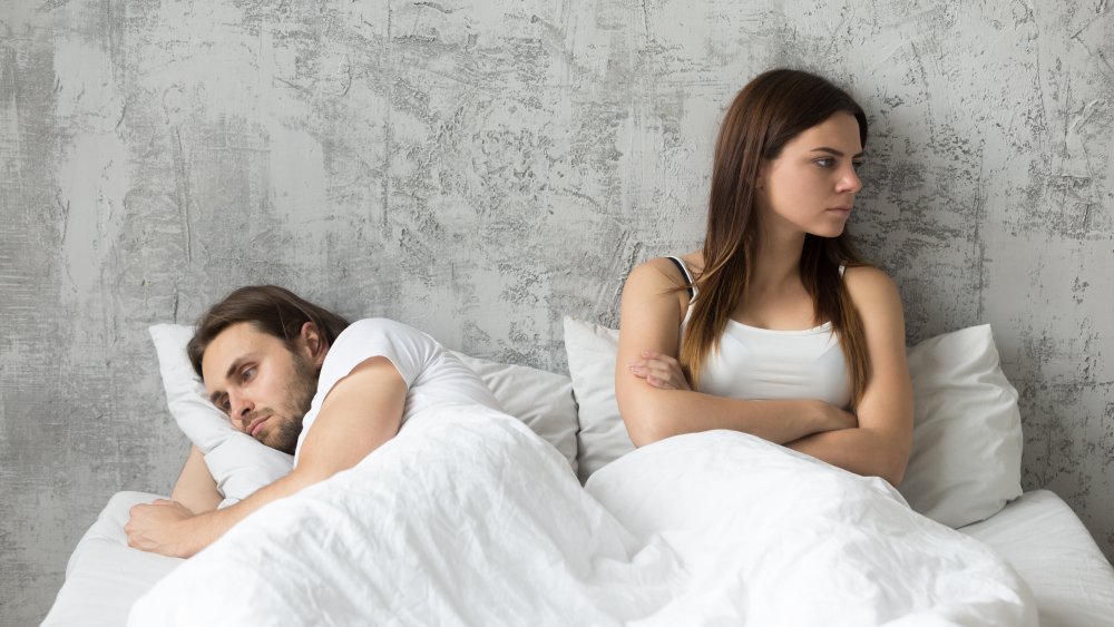man in bed pain