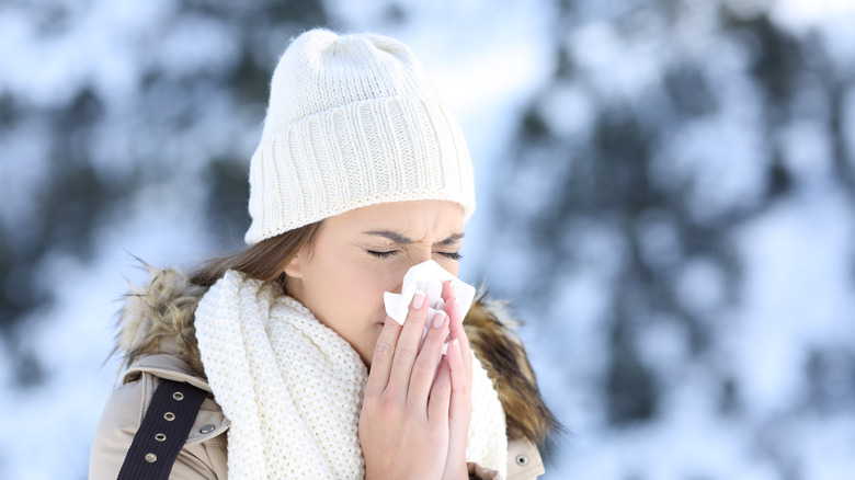 woman blowing nose