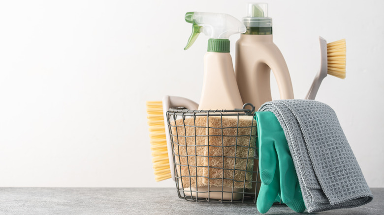 A wire basket filled with natural cleaning products