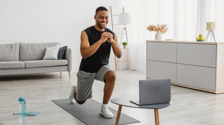 A man does lunges at home