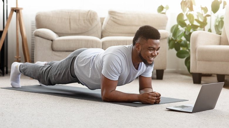 A man is doing a plank at home
