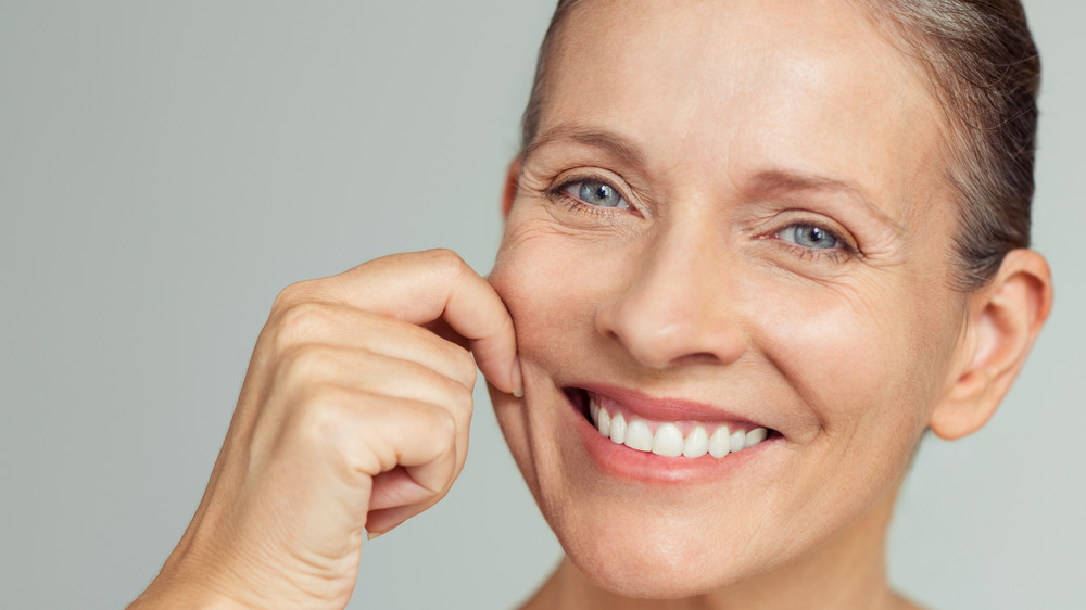 woman stretching cheek