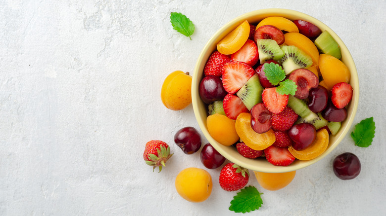 bowl of mixed fruit on a white counter top 