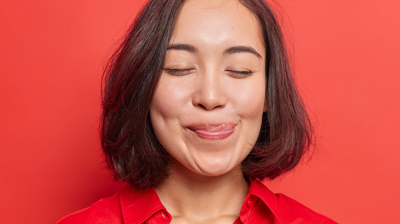 Woman licking their lips