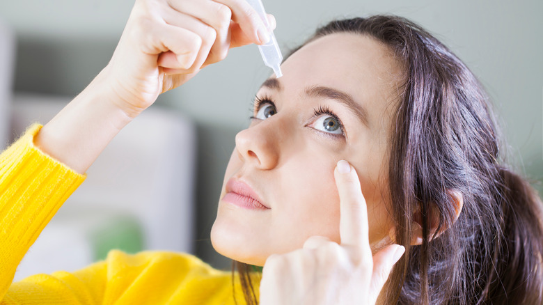 Woman uses eye drops for eye irritation 