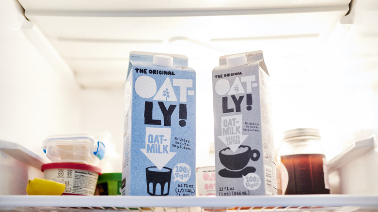 Two cartons of Oatly's oat milk in a fridge