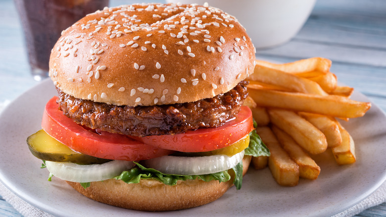 plant-based hamburger with fries on plate