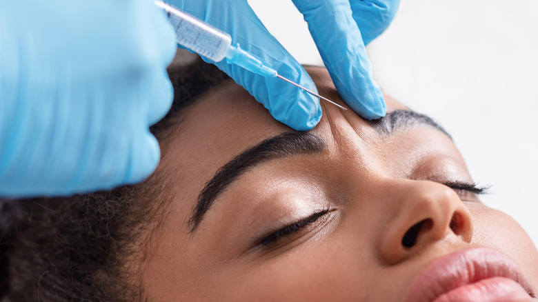 Black woman getting skin injection