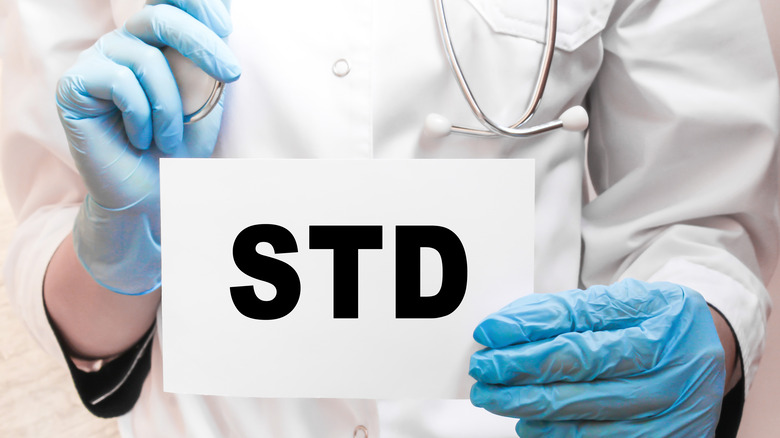 doctor holding std signage