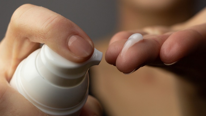 woman applying retinoid cream