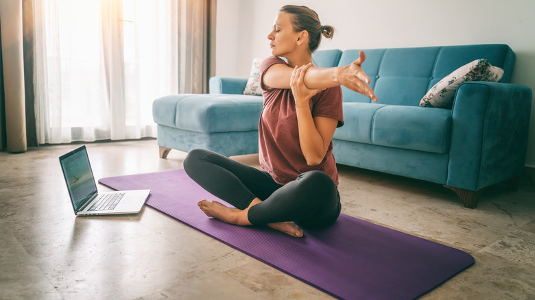 Woman stretching on yoga mat