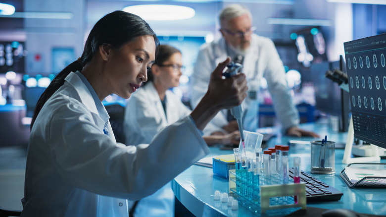 scientists working in laboratory with test tubes