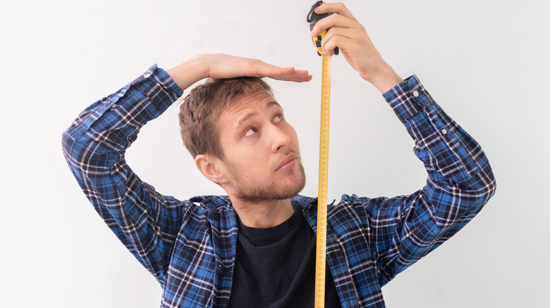 man measuring height