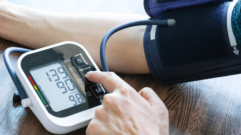 Arm wearing a blood pressure cuff