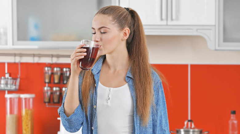 woman looking at her supplement pill