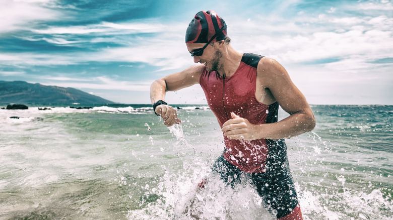 Male swimmer checking heart rate