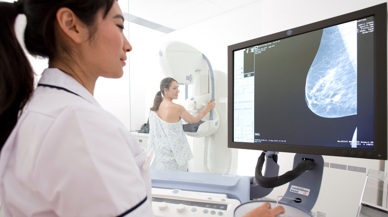 Medical provider looking at the screen during a mammogram