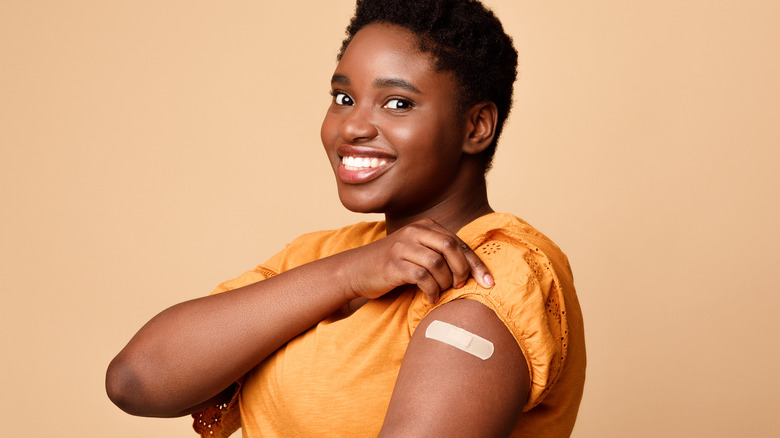 Woman with vaccine bandage