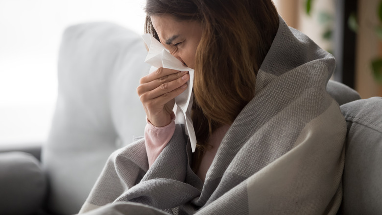 Woman blowing nose