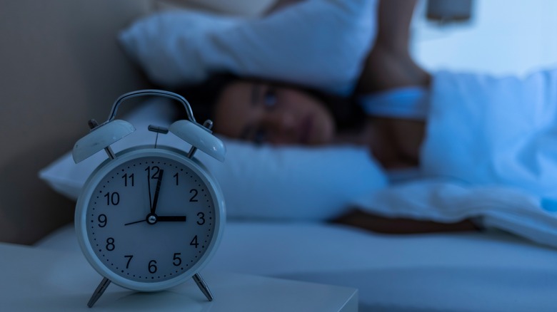 woman with insomnia lying in bed 