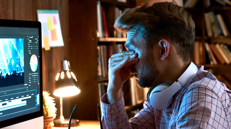 tired employee rubbing eyes unable to work
