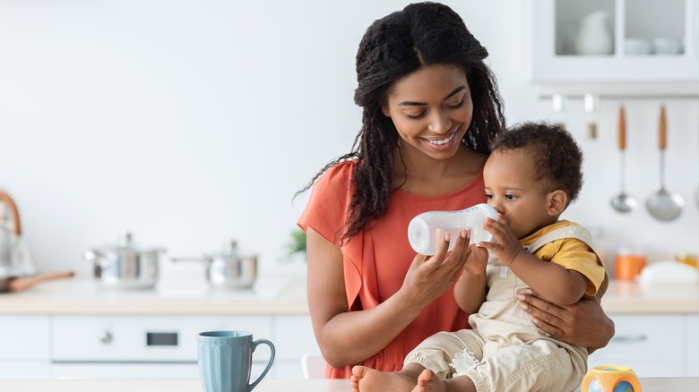 Baby drinking bottle of water