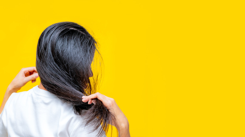 woman holding damaged hair