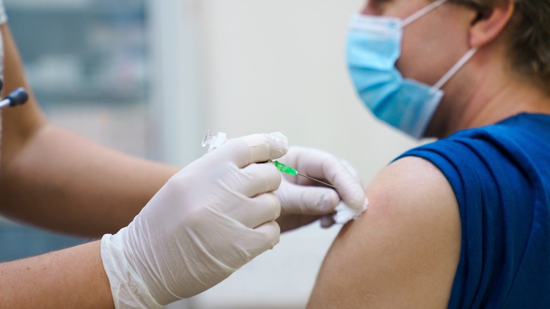 Masked patient receiving vaccine