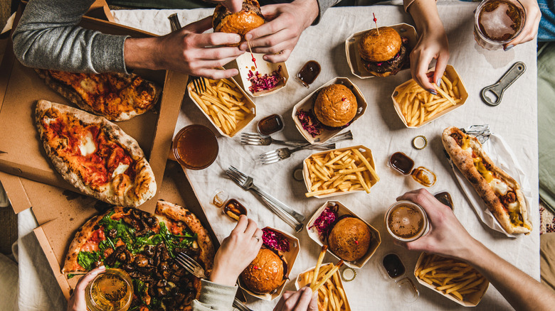 Four friends gathered around junk food