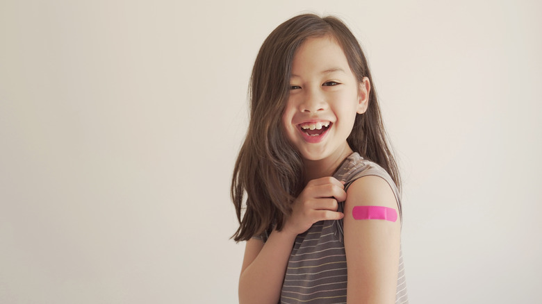 a girl smiling with her booster shot