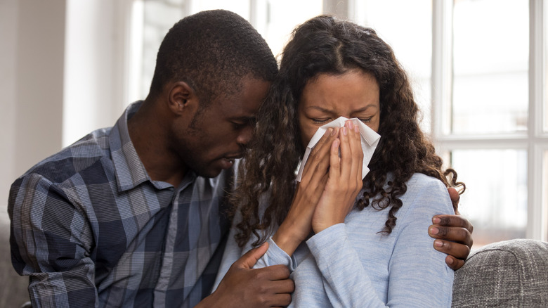 couple hugging crying