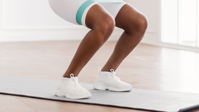 woman working out legs indoors