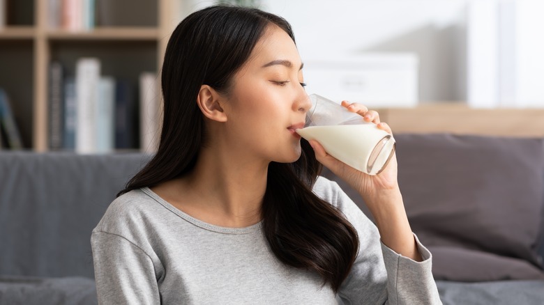 woman drinking a glass of milk