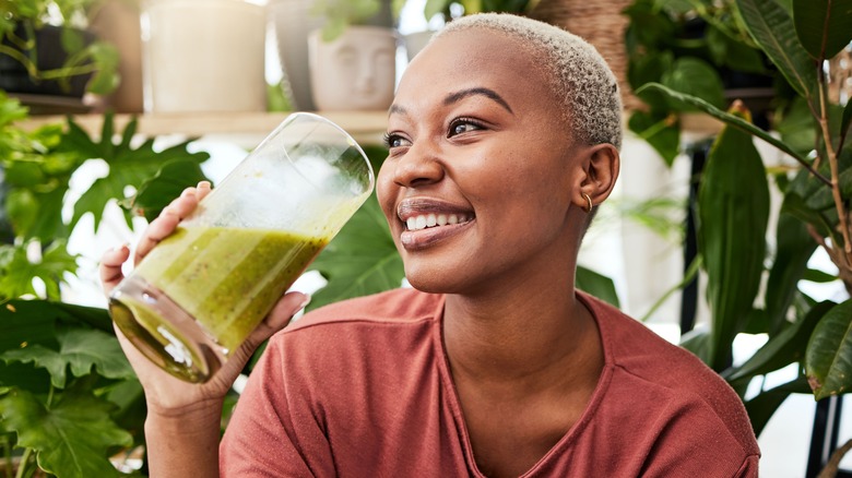 woman enjoying a green smoothie