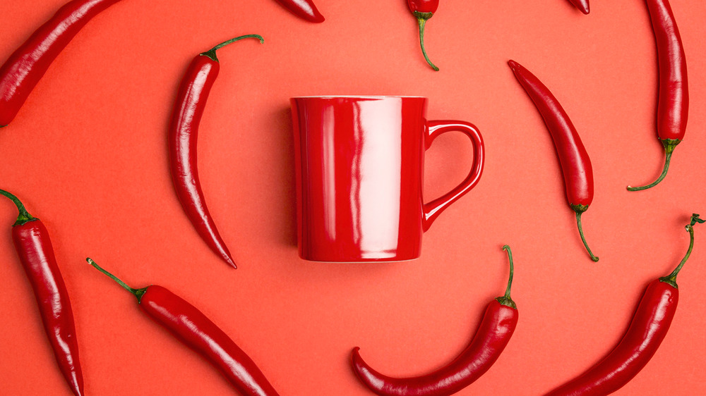 Cayenne peppers surrounding a red mug